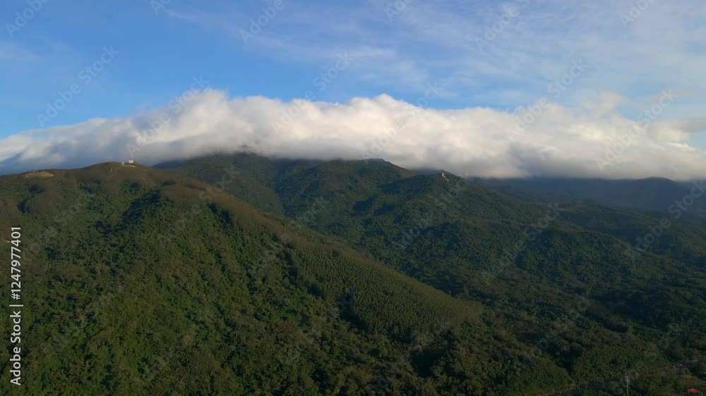 Explore the breathtaking aerial view of a cloud sea draping over lush mountains under a vibrant blue sky in beautiful surroundings Explore the breathtaking aerial view of a cloud sea draping over lush mountains under a vibrant blue sky in beautiful surroundings