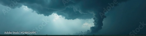 Dark grey sky with swirling clouds and funnel cloud in foreground, destructive, thunderstorm photo