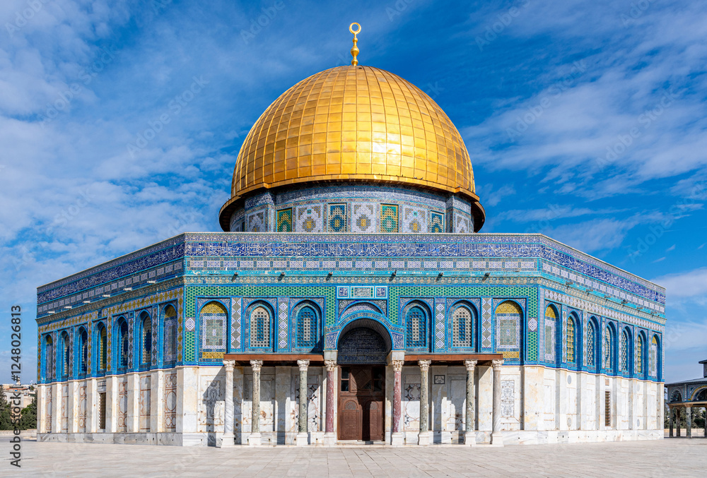 Fototapeta premium The Dome of the Rock, the sacred Al Aqsa Mosque with a dark blue sky and scattered clouds on Jerusalem's Temple Mount