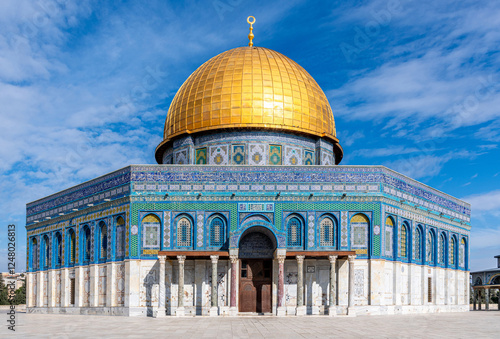 The Dome of the Rock, the sacred Al Aqsa Mosque with a dark blue sky and scattered clouds on Jerusalem's Temple Mount
