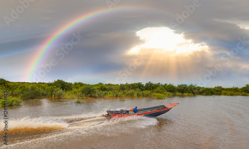 Tonle Sap lake, Siem reap Province, Cambodia. Fisherman in his boat, Floating village of Kompong Phluk, Cambodia. photo