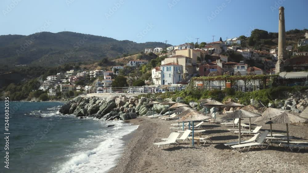 A desolated beach of a coastal town in Lesvos with colorful buildings by the sea. A desolated beach of a coastal town in Lesvos with colorful buildings by the sea.