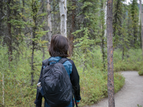 Woman walking in the forest at Denali National Park and Preserve. Alaska. USA.