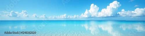 Brilliant blue sky and fluffy clouds reflected perfectly in still, shallow Florida beach water , nature, idyllic