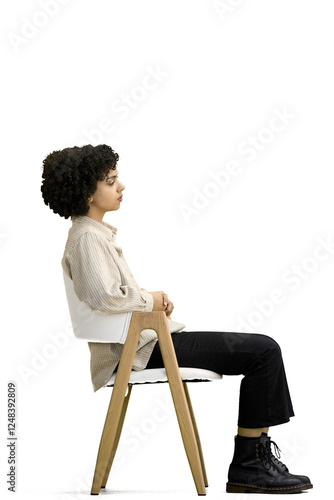 A woman, full-length, on a white background, sitting on a chair