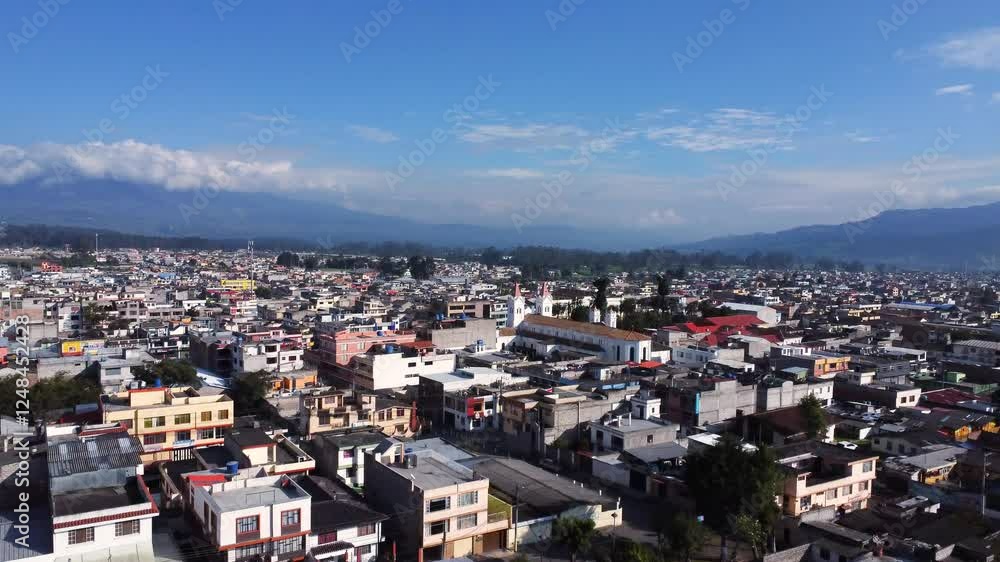 Drone traveling frontal of the city of Machachi and at the end reveals the main church Drone traveling frontal of the city of Machachi and at the end reveals the main church
