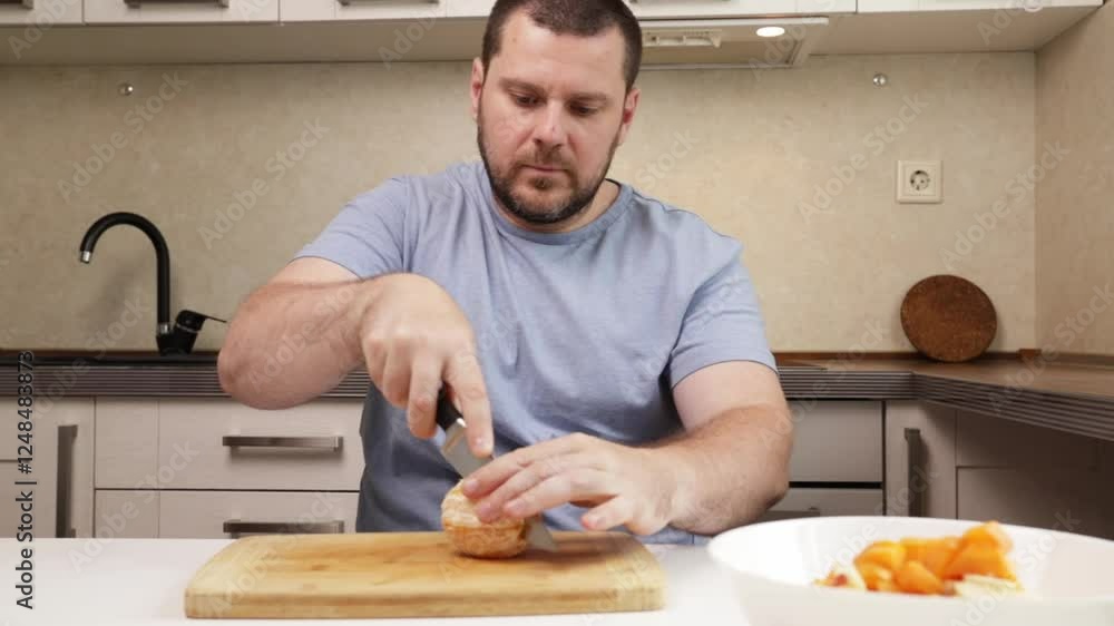 man cutting orange in the kitchen, breakfast preparation, fruit ingredient, cook recipe, food preparation man cutting orange in the kitchen, breakfast preparation, fruit ingredient, cook recipe, food preparation