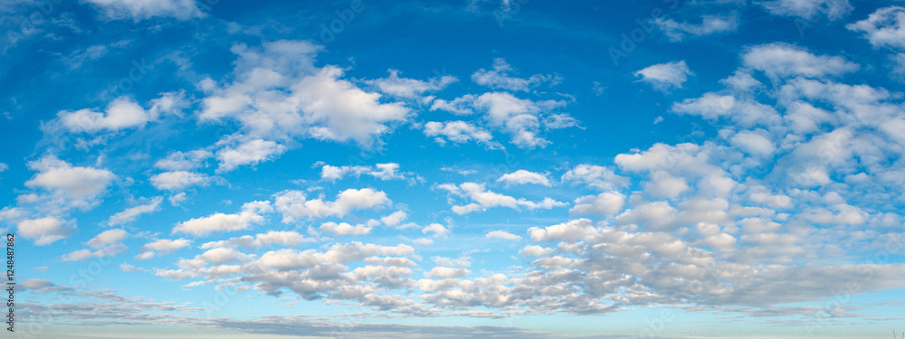 Blue sky adorned with beautiful, fluffy clouds, creating a peaceful and stunning view Blue sky adorned with beautiful, fluffy clouds, creating a peaceful and stunning view