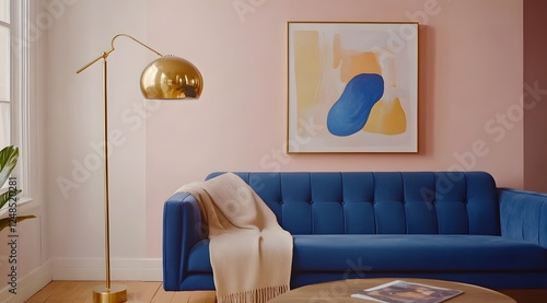 Stylish blue sofa, modern art, pink wall, living room interior design photo