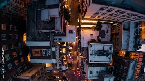 Wallpaper Mural Aerial video shot with a fisheye lens captures a cityscape at sunset, creating a spherical, immersive view of urban architecture and glowing lights. Torontodigital.ca
