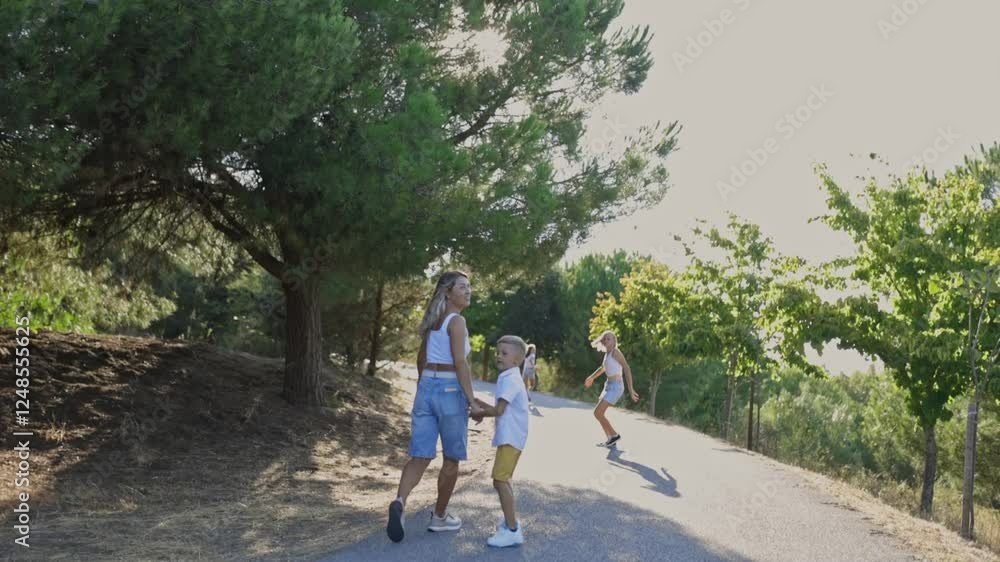 Happy family walking and running in a sunny park Happy family walking and running in a sunny park
