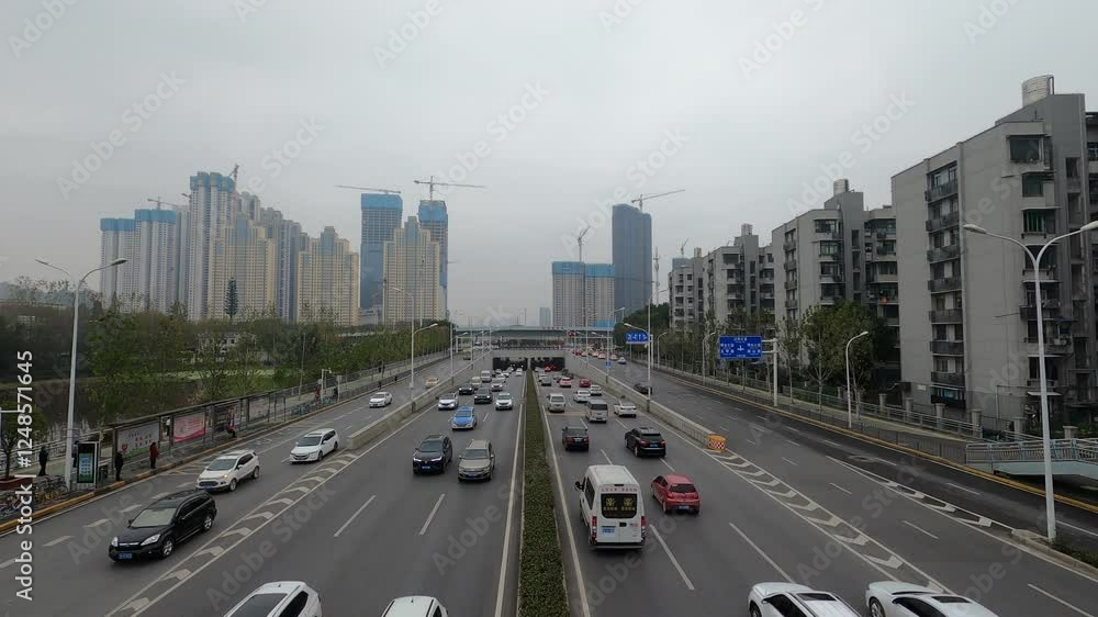 Cloudy day traffic on Jiangcheng Avenue in Wuhan with dark clouds looming overhead Cloudy day traffic on Jiangcheng Avenue in Wuhan with dark clouds looming overhead