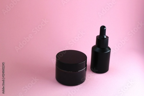 Cosmetic bottle on a pink background. Place for advertising cosmetics. Blank for a beautician's business card. Skin care products. Hair care product. Oil for split ends of hair. Place for advertising.