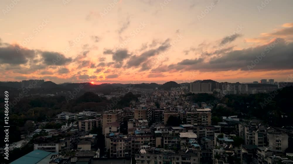 Aerial view of Guiyang city glowing at sunset showcasing urban landscape and natural beauty Aerial view of Guiyang city glowing at sunset showcasing urban landscape and natural beauty