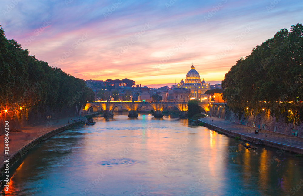 View from the Tiber on Ponte Sant'Angelo and St. Peter's Basilica in the twilight, Rome, Italy.