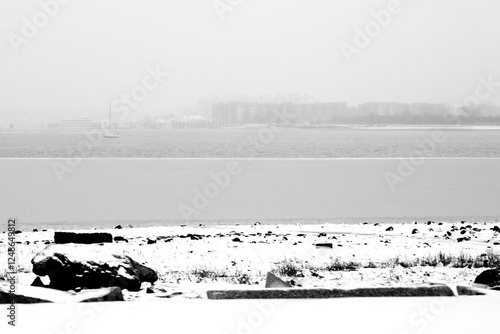 Boston in Snow: A tranquil winter landscape over the Dorchester Bay Basin and Malibu Beach in Massachusetts, USA, Roadside view from the I-93 Interstate Highway photo