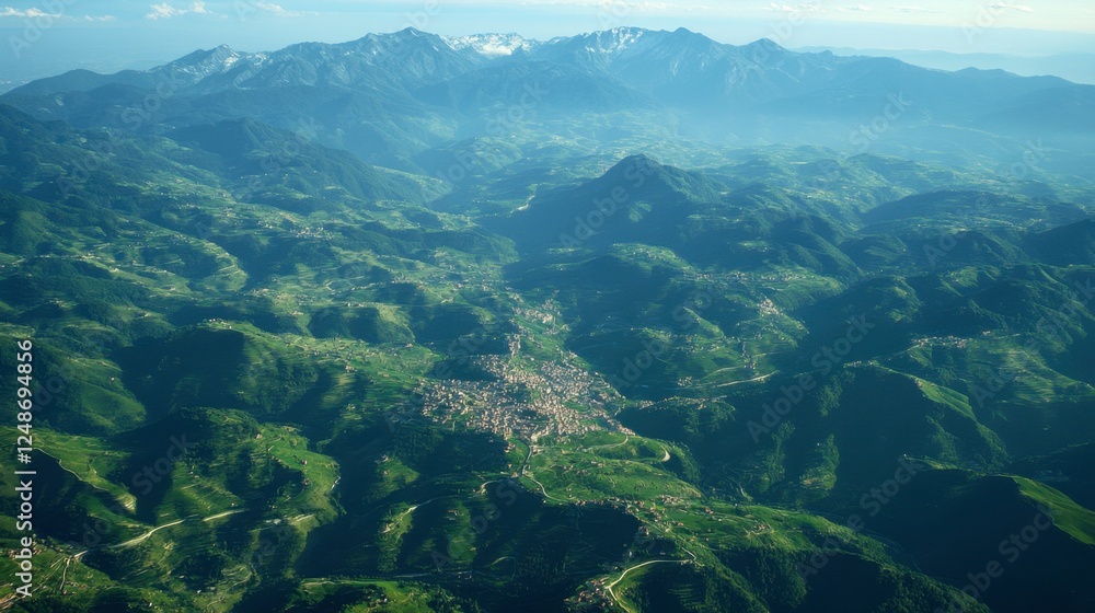 Fototapeta premium A birds-eye view of the Italian Alps, with winding mountain roads and small villages scattered throughout the region.