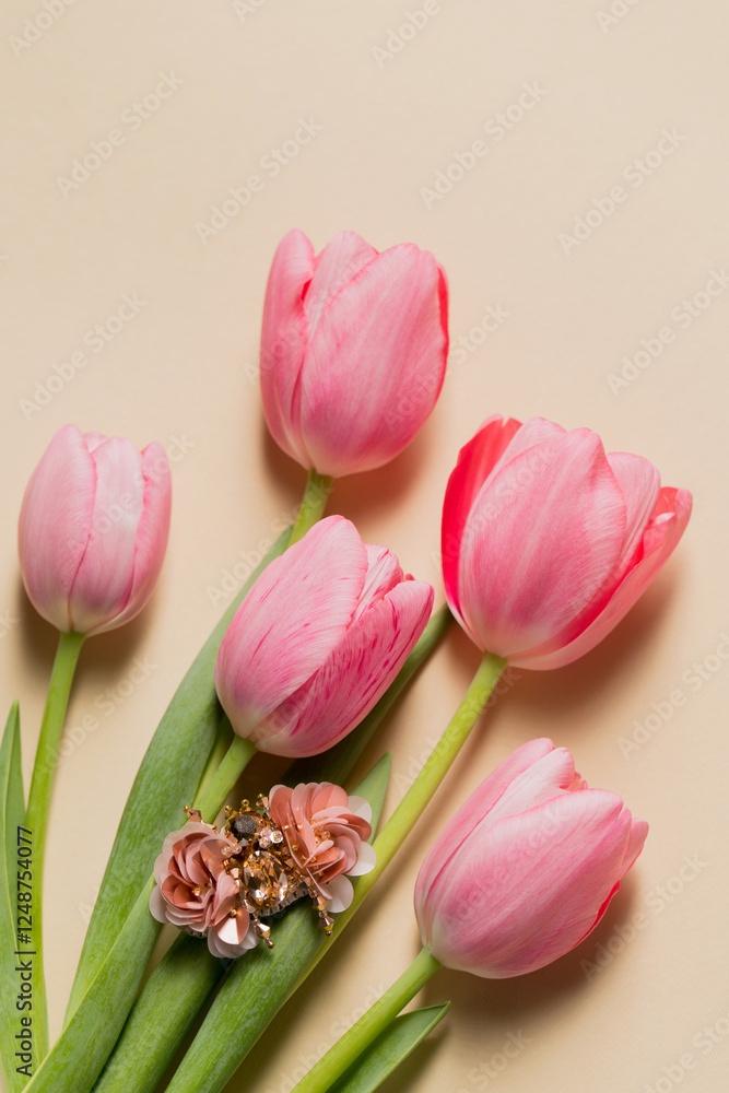Fototapeta premium Spring still life handmade beetle brooch with pink bottom tulips, top view