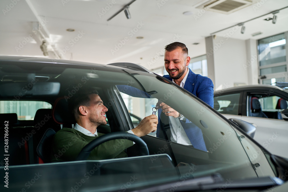 Smiling car salesman in a dealership hands over keys to a satisfied customer sitting in a new vehicle. The interaction highlights a successful car purchase and customer service experience Smiling car salesman in a dealership hands over keys to a satisfied customer sitting in a new vehicle. The interaction highlights a successful car purchase and customer service experience