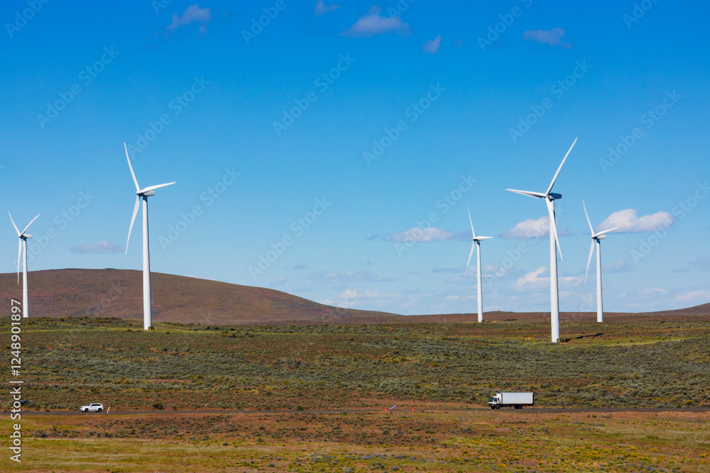 Wind turbines on the rolling hills of Kittikas county in Washington state, tall white towers with blades for energy generation. Wind turbines on the rolling hills of Kittikas county in Washington state, tall white towers with blades for energy generation.
