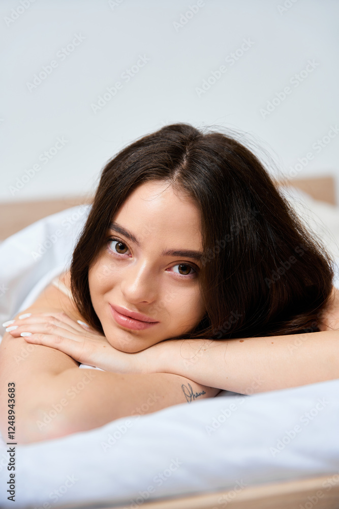 Captivating young woman relaxing in a sunlit bedroom with serene expressions Captivating young woman relaxing in a sunlit bedroom with serene expressions
