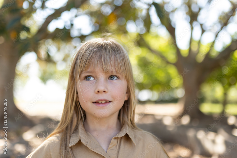 Young girl enjoying nature in sunlit park