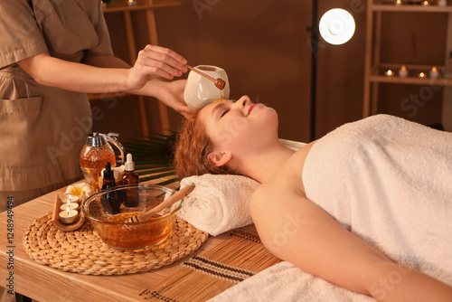 Massage therapist pouring h...
