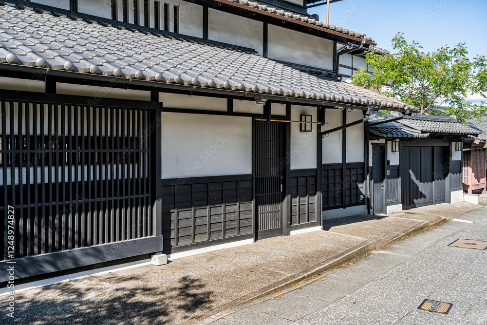 Medieval traditional Japanese architecture. Facade of a house with wooden doors in Arashiyama district of Kyoto, Japan. Medieval traditional Japanese architecture. Facade of a house with wooden doors in Arashiyama district of Kyoto, Japan.