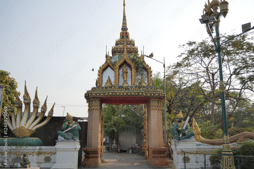 Fototapeta premium Gate at Wat King Kaew, Samut Prakan. Thai architecture, ornate details, temple entrance.