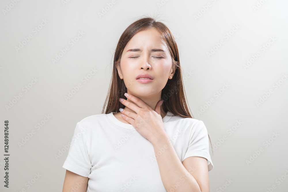 Sickness in inflaming asian young woman, girl use hand check self touch at sore throat, pain thyroid gland on neck or disease reflux, acid of suffer people on wall background. Medical and healthcare. Sickness in inflaming asian young woman, girl use hand check self touch at sore throat, pain thyroid gland on neck or disease reflux, acid of suffer people on wall background. Medical and healthcare.