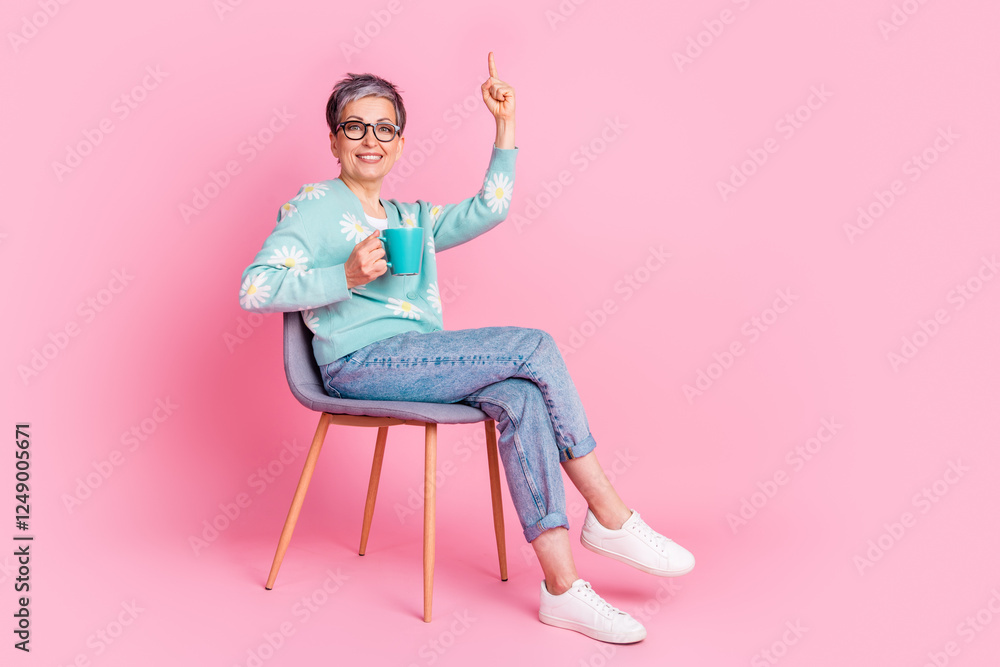 Mature woman with grey hair smiling on a pink background in casual trendy fashion Mature woman with grey hair smiling on a pink background in casual trendy fashion