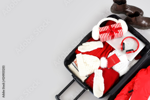 Open suitcase with winter a...