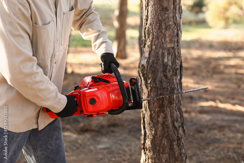 Wallpaper Mural Male lumberjack sawing tree in forest, closeup Torontodigital.ca