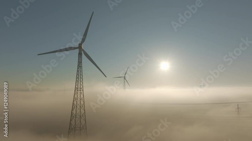 Wallpaper Mural Wind turbines in backlight above clouds and fog. Drone video. Torontodigital.ca