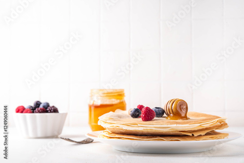 Traditional Maslenitsa food, Eastern European Slavic thin pancakes crepes, with various sweet spreads, toppings and fillings - honey, berries, jams  photo