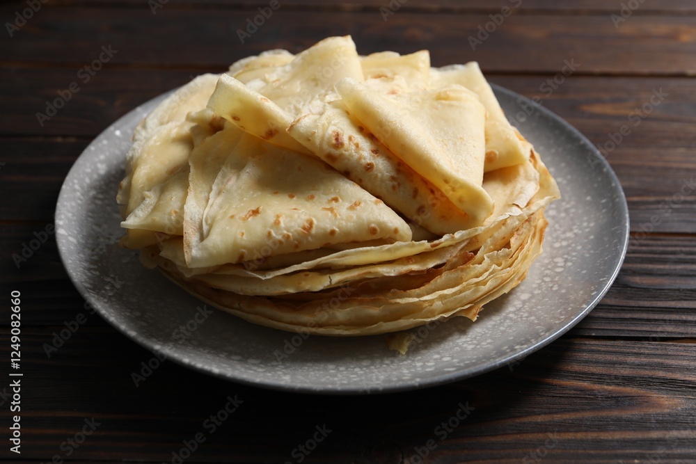 Tasty crepes on wooden table, closeup view Tasty crepes on wooden table, closeup view