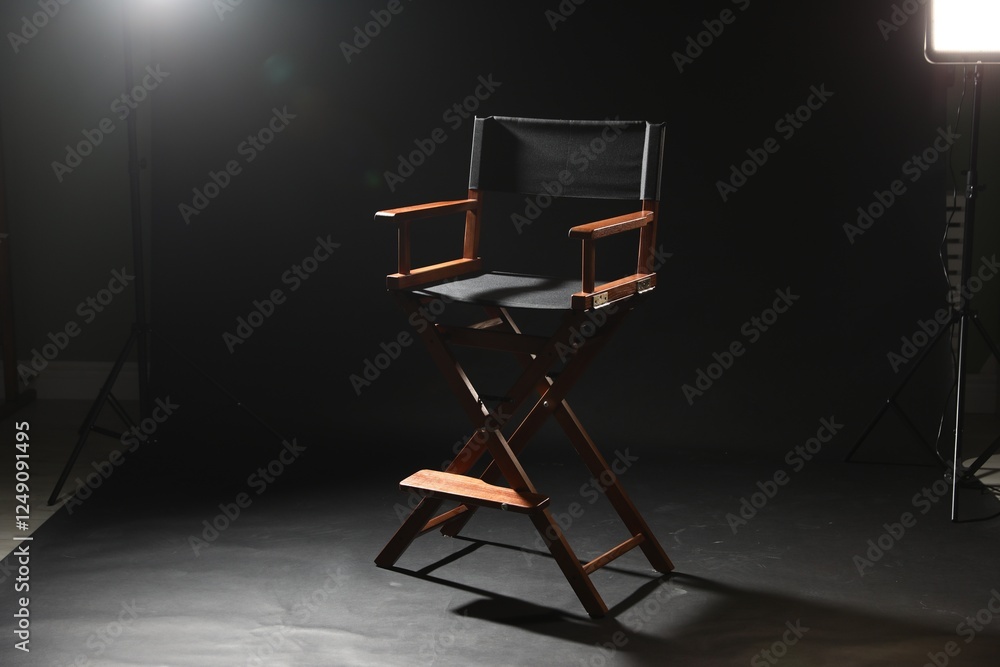 One empty director's chair on black background One empty director's chair on black background