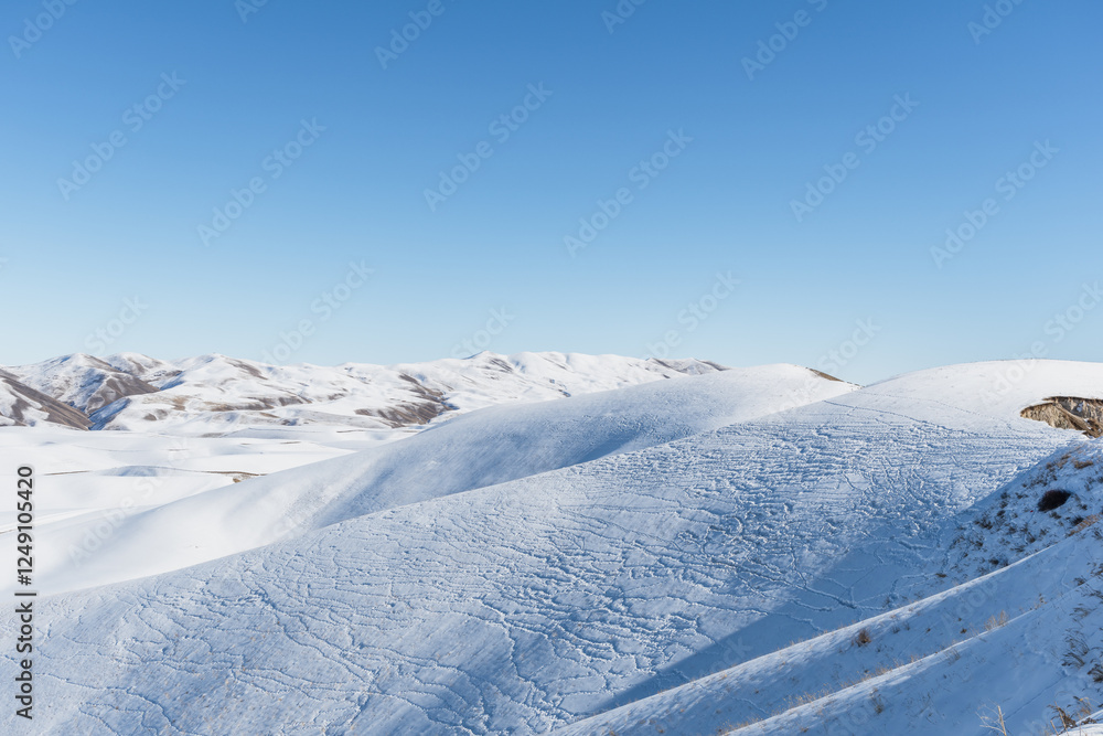Snow covered hills and clear blue sky. Snow covered hills and clear blue sky.