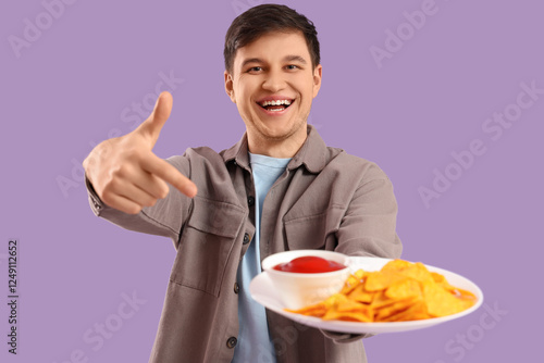 Young man with tasty nachos...