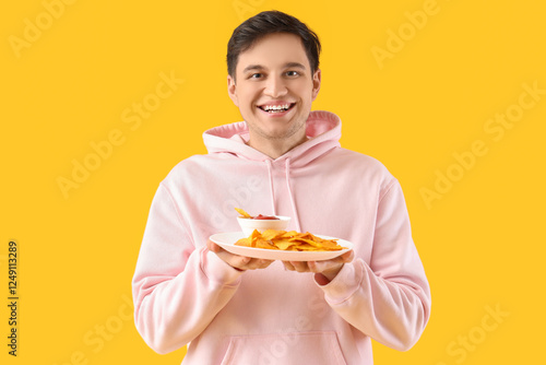 Young man with tasty nachos...