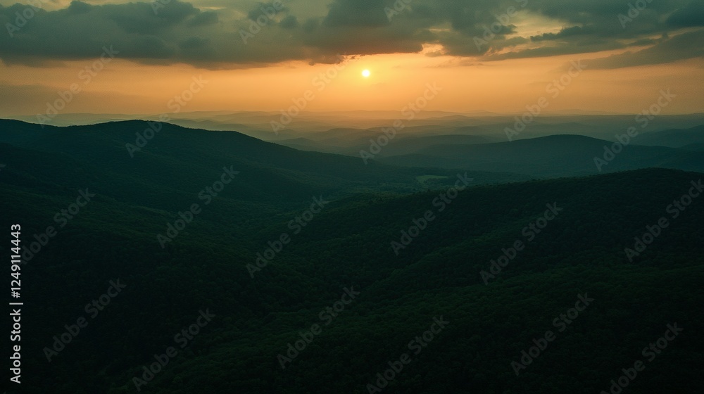 Overlooking Forested Mountain Ridges at Dusk with a Golden Sun Overlooking Forested Mountain Ridges at Dusk with a Golden Sun
