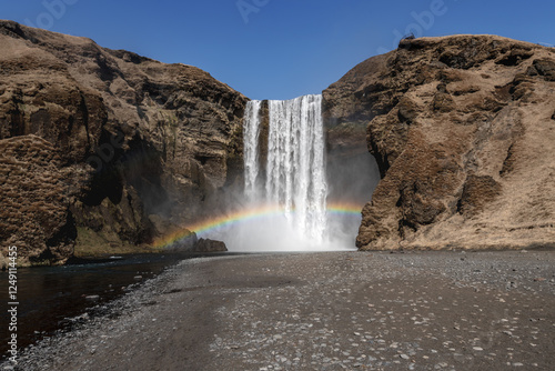 Iceland waterfall with a rainbow, mist and no people photo