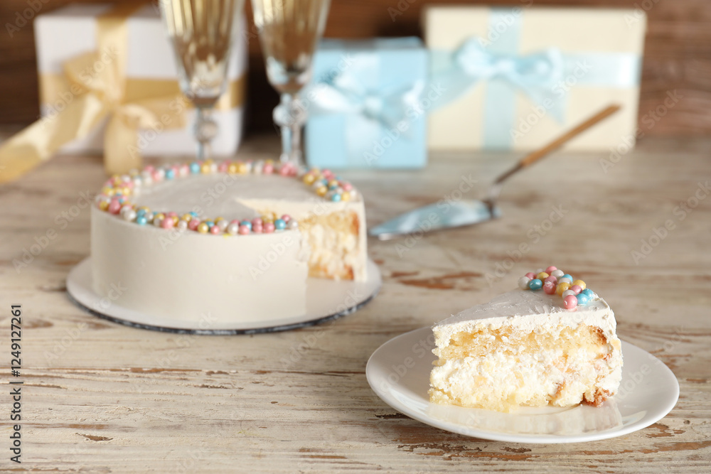 Φωτογραφία Tasty birthday cake, glasses of champagne and gifts on light wooden table