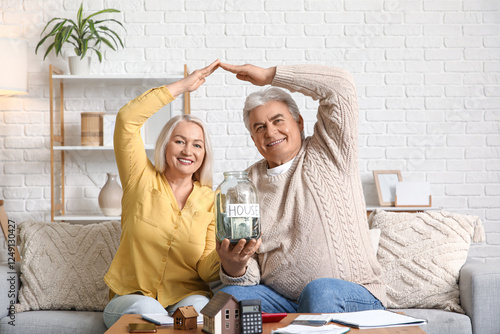 Senior couple with jar of m...