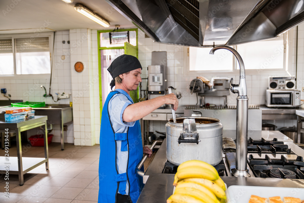 Fototapeta premium Chef preparing meals in nursing home kitchen