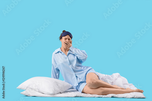 Sleepy young woman in pajam...