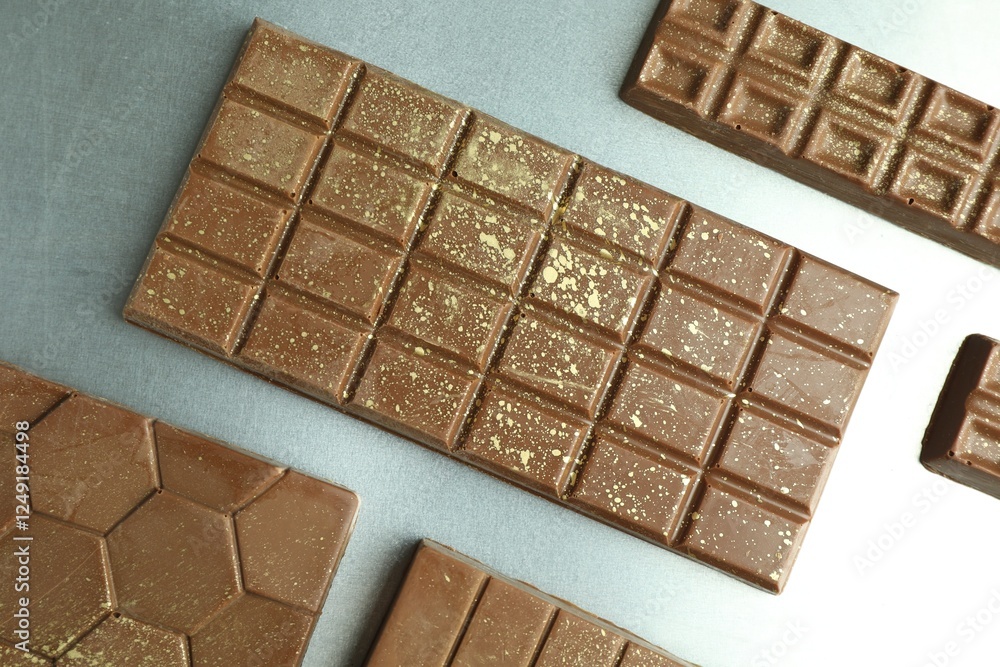 Different tasty Dubai chocolate bars with pistachios and knafeh on grey table, flat lay Different tasty Dubai chocolate bars with pistachios and knafeh on grey table, flat lay