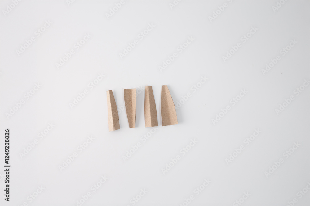 step in creative process, Cut Pieces, Four cut pieces of cardboard, which will be used to form the legs of grasshopper handmade toy. part of DIY project for kids step in creative process, Cut Pieces, Four cut pieces of cardboard, which will be used to form the legs of grasshopper handmade toy. part of DIY project for kids