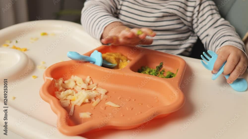 A toddler sits in a high chair, interacting with various food textures on their plate. Colorful dishes include mashed vegetables and pureed fruits, highlighting the joys of early eating experiences