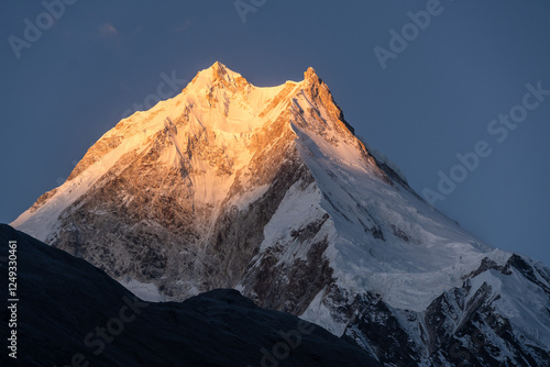 Manaslu, Nepal: Dramatic sunrise over the Manaslu peak (8163m) from the Shyala village along the Manaslu circuit trek trek in Nepal photo